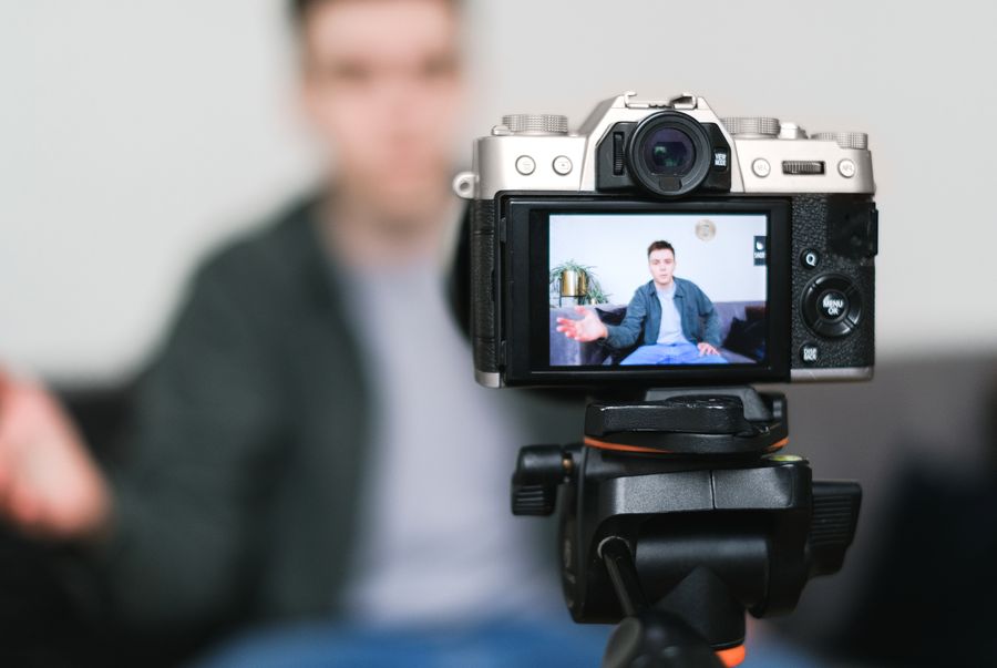 Creator recording a video with a mirrorless camera on a tripod