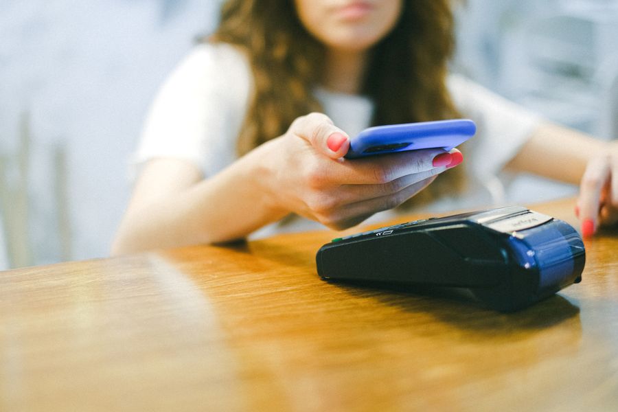 Person completing a payment with their smartphone